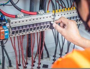 commercial electrician in Essex fixing a fuse board